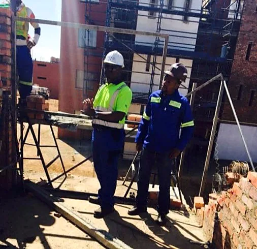 Supervisors reviewing brickwork and scaffolding