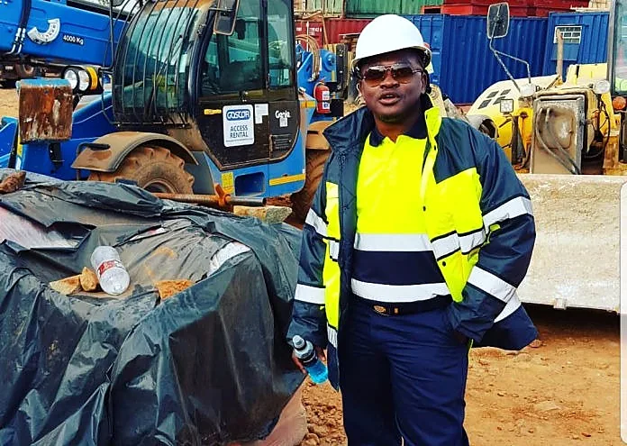 Site supervisor beside plant equipment