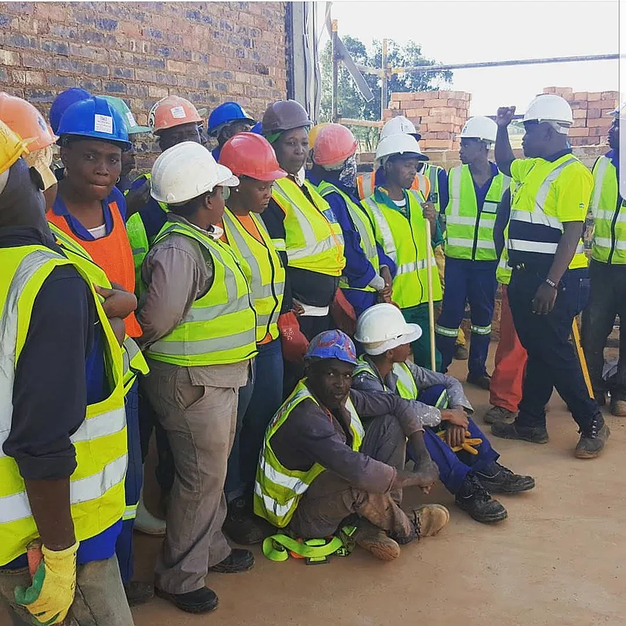 ATPGROUP site team in hard hats and reflective vests on a construction site